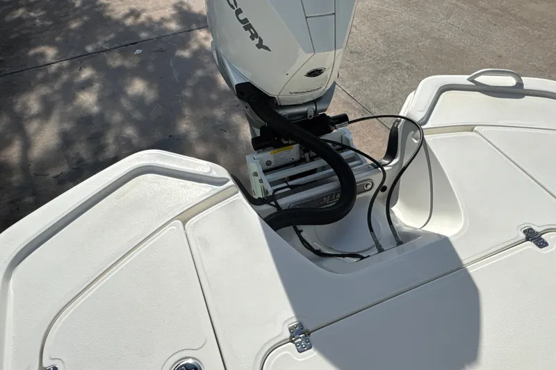 Slide: The Image of 2025 Mako 24 APEX boat engine detail with Mercury motor on white deck. - 15