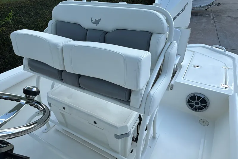 Slide: The Image of 2025 Mako 24 APEX boat interior with cushioned seating and steering wheel. - 19