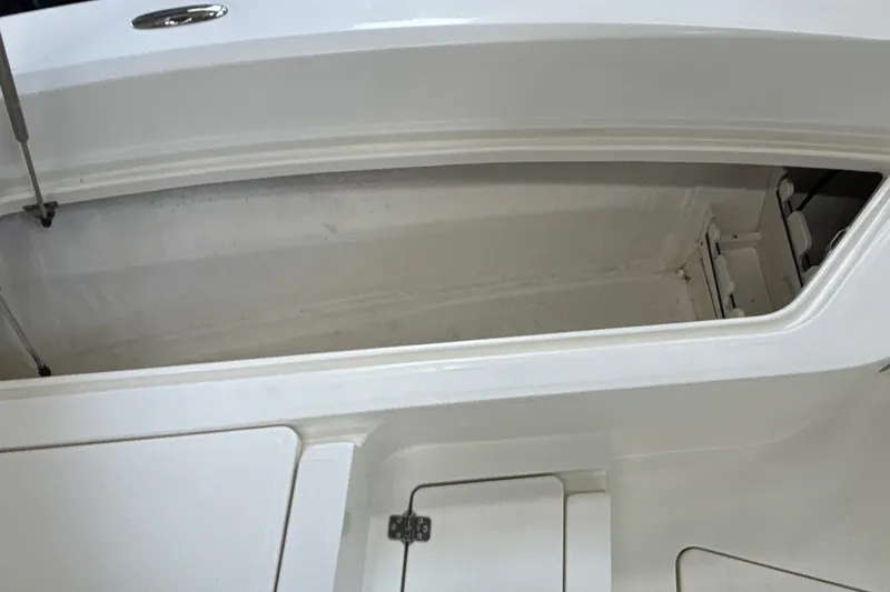Slide: The Image of Open storage compartment on a 2025 Mako 24 APEX boat, showcasing interior space. - 44