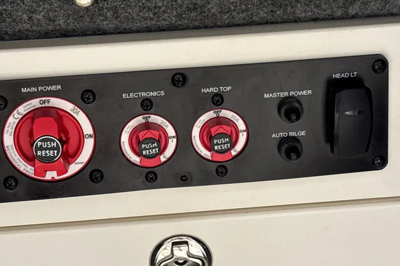 Slide: The Image of Control panel of 2025 Mako 24 APEX boat with switches and reset buttons. - 46