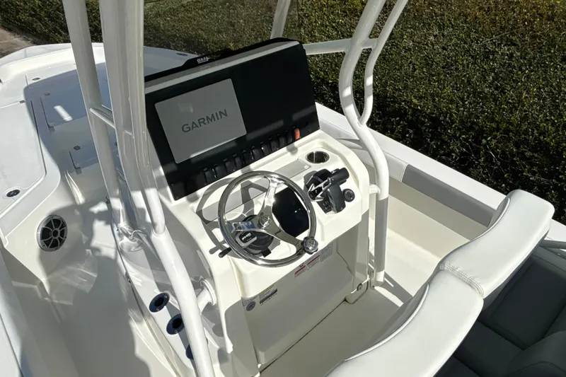 Slide: The Image of 2025 Mako 24 APEX boat console with Garmin navigation system and steering wheel. - 23