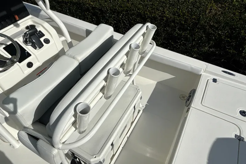Slide: The Image of Interior view of 2025 Mako 24 APEX boat with rod holders and seating. - 30