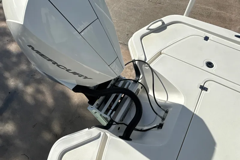 Slide: The Image of 2025 Mako 24 APEX boat with Mercury outboard motor, rear deck view. - 16