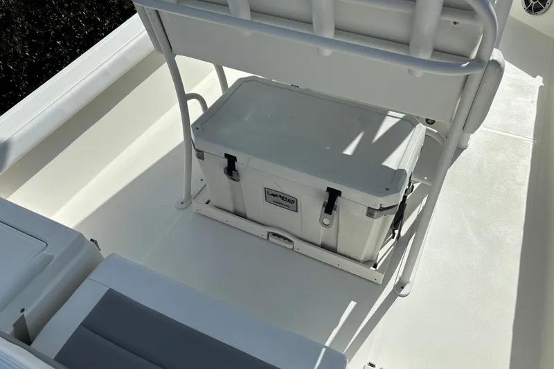 Slide: The Image of 2025 Mako 24 APEX boat interior with cooler under seating. - 14