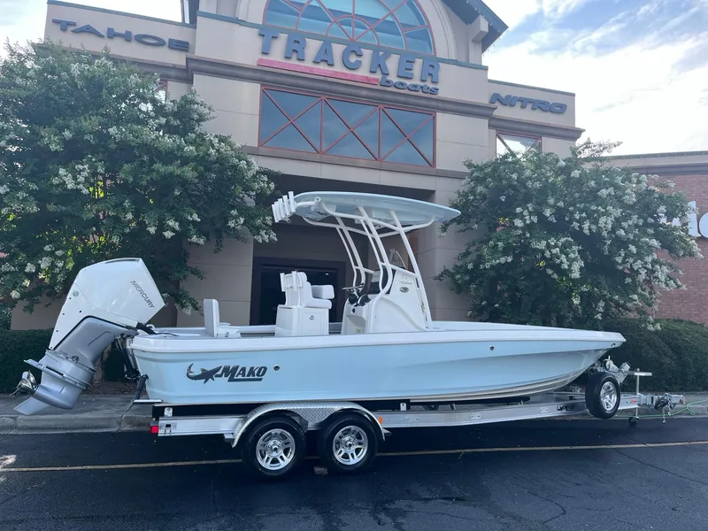 The Image of 2025 Mako 24 APEX boat on trailer outside Tracker Boats dealership. - 0