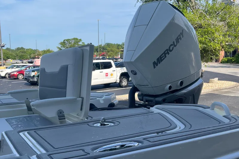 Slide: The Image of 2025 Mako 24 APEX boat with Mercury outboard motor in parking lot. - 3