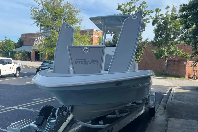 Slide: The Image of 2025 Mako 24 APEX boat on trailer in urban setting. - 4