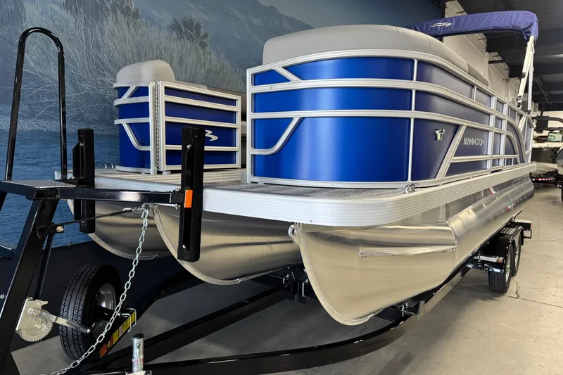 Slide: The Image of 2026 Bennington 21 SSB pontoon boat with blue exterior on a trailer. - 6