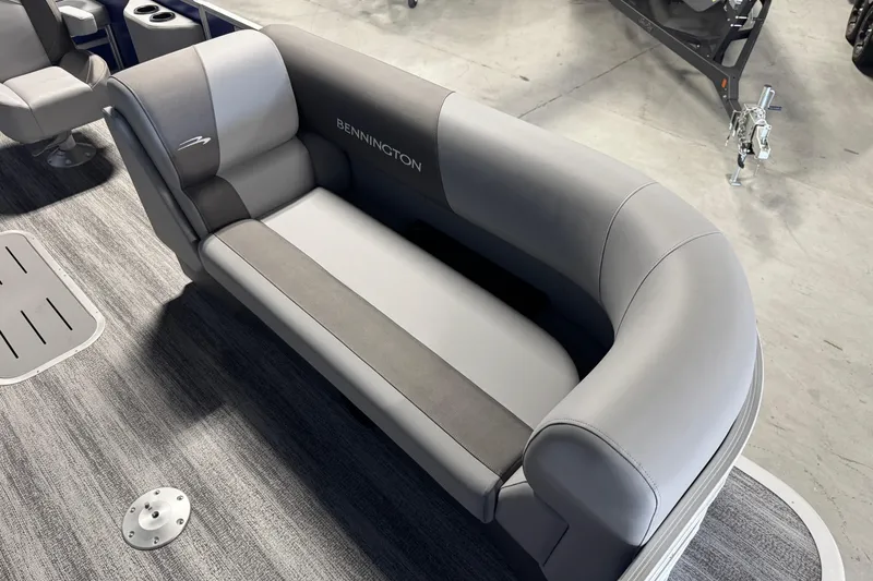 Slide: The Image of 2026 Bennington 21 SSB boat interior with gray seating and carpeted flooring. - 9