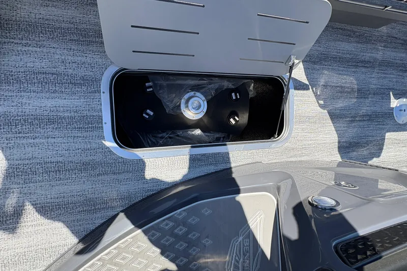 Slide: The Image of Open storage compartment on 2026 Bennington 22 MSB boat, showcasing interior details. - 16