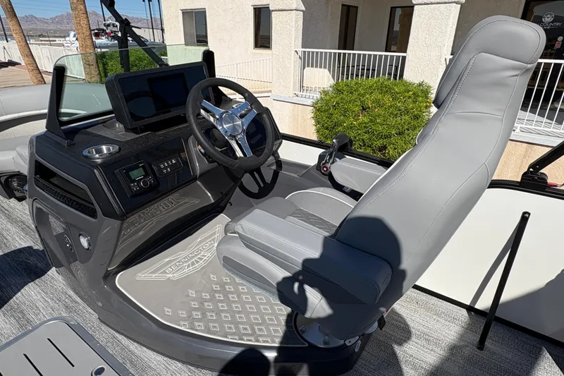 Slide: The Image of 2026 Bennington 22 MSB boat helm with modern steering and controls. - 8