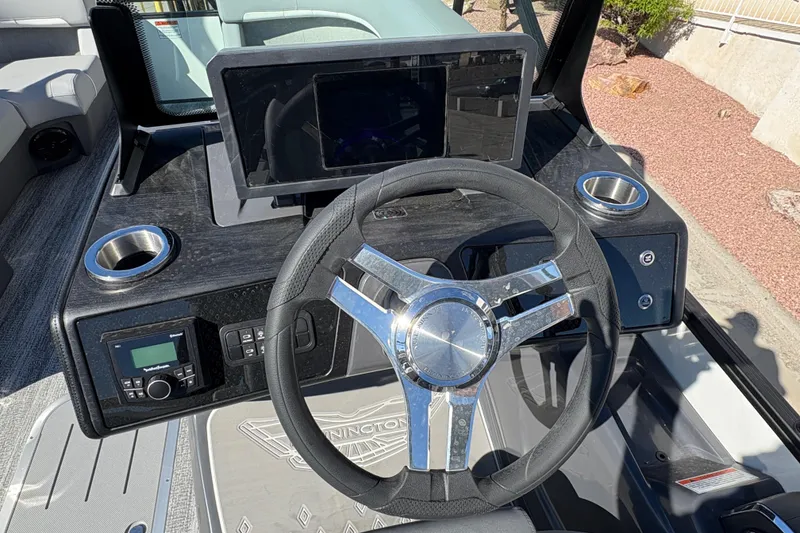 Slide: The Image of Steering console of 2026 Bennington 22 MSB boat with modern controls and cup holders. - 9