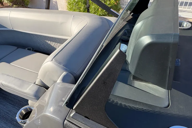 Slide: The Image of 2026 Bennington 22 MFB boat interior with gray seating and cup holder. - 15