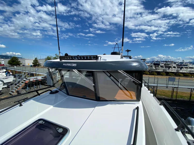 Slide: The Image of 2019 Sargo 36 Explorer boat with sleek design, docked under a bright blue sky. - 11