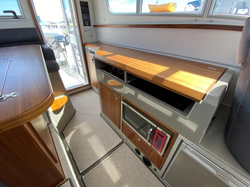 Slide: The Image of Interior of 2019 Sargo 36 Explorer boat with wooden cabinetry and modern appliances. - 16