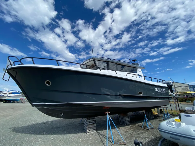 Slide: The Image of 2019 Sargo 36 Explorer boat on stands under a blue sky with clouds. - 2