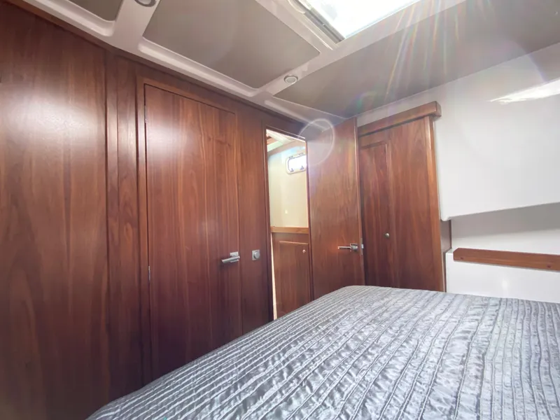 Slide: The Image of Interior of 2019 Sargo 36 Explorer with wooden cabinetry and a bed. - 21