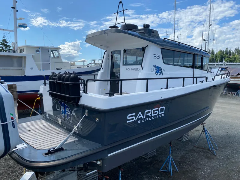 Slide: The Image of 2019 Sargo 36 Explorer boat on stands, docked outdoors under a blue sky. - 3
