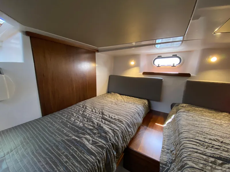 Slide: The Image of 2019 Sargo 36 Explorer cabin with twin beds, wooden accents, and soft lighting. - 30