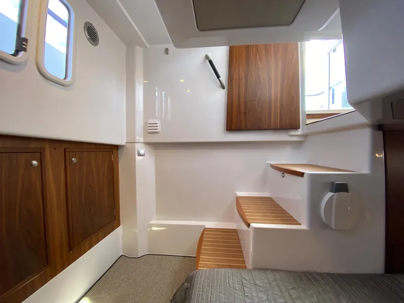 Slide: The Image of Interior of 2019 Sargo 36 Explorer boat with wooden cabinets and stairs. - 33