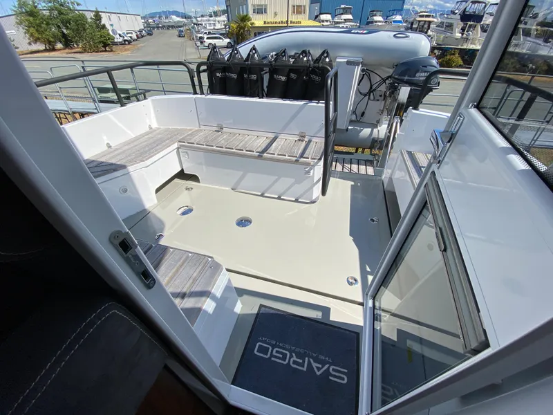 Slide: The Image of 2019 Sargo 36 Explorer boat deck with seating and equipment, docked at a marina. - 36