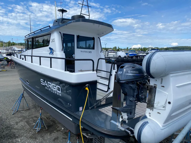 Slide: The Image of 2019 Sargo 36 Explorer boat with Yamaha engine, docked on land under a blue sky. - 4