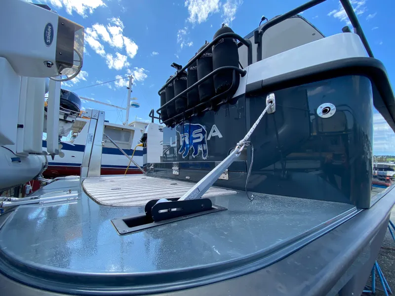 Slide: The Image of 2019 Sargo 36 Explorer boat docked, showcasing sleek design and modern features under a blue sky. - 5