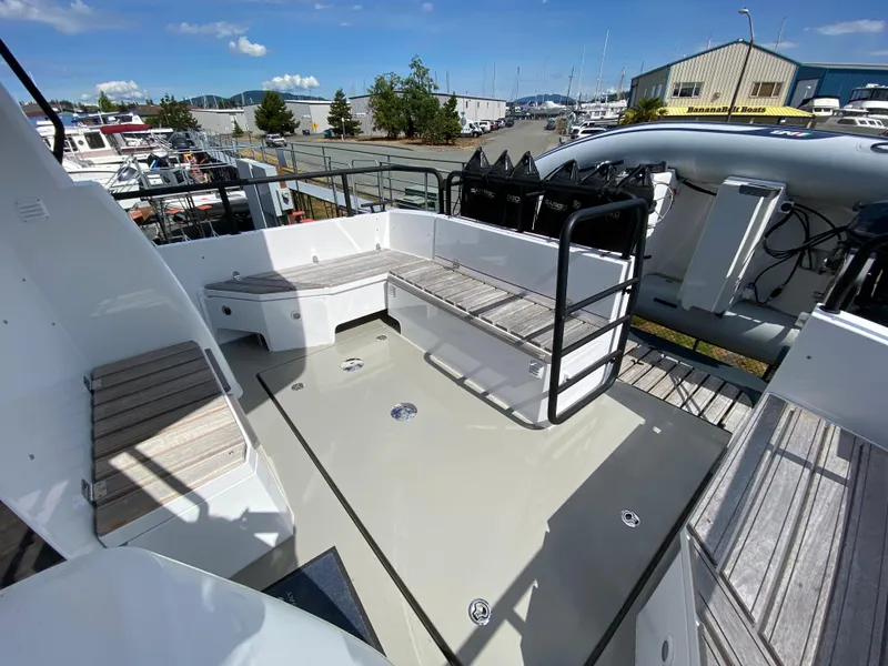 Slide: The Image of Sargo 36 Explorer 2019 boat deck with seating, docked at a marina under clear skies. - 9
