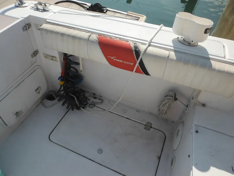 Slide: The Image of 2002 Pro-Line 23 Walk boat interior with storage compartments and coiled ropes. - 17