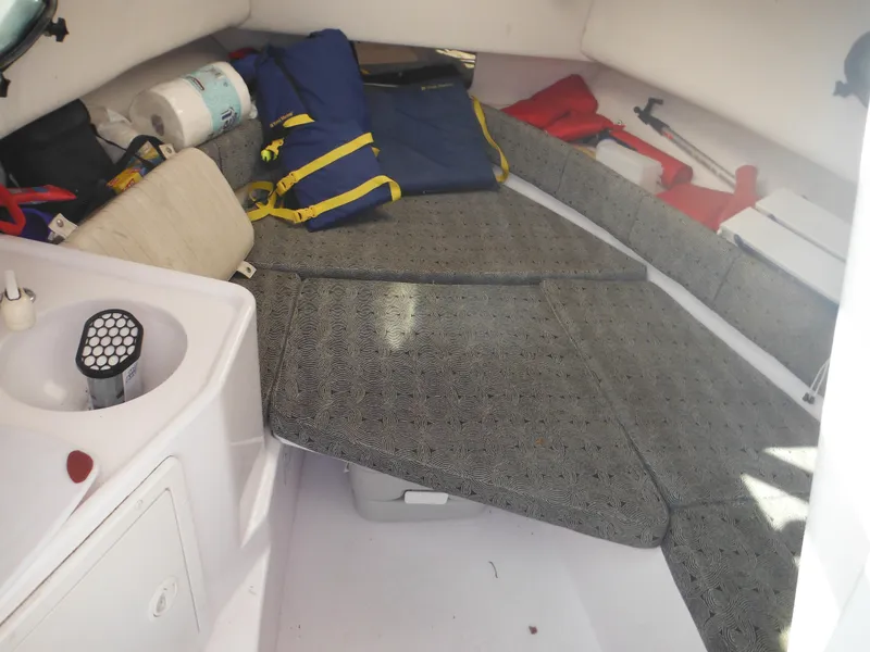 Slide: The Image of Interior of a 2002 Pro-Line 23 Walk boat with cushions and safety gear. - 19