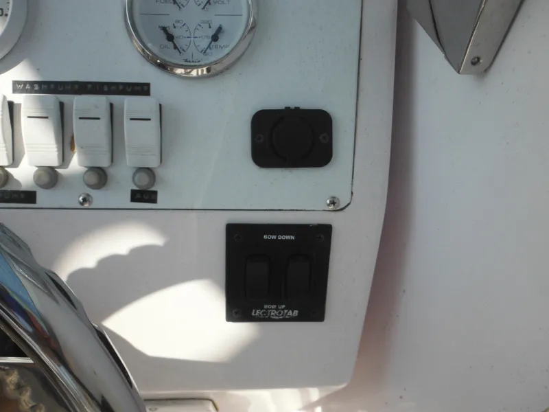 Slide: The Image of Control panel of a 2002 Pro-Line 23 Walk boat with switches and gauges. - 24