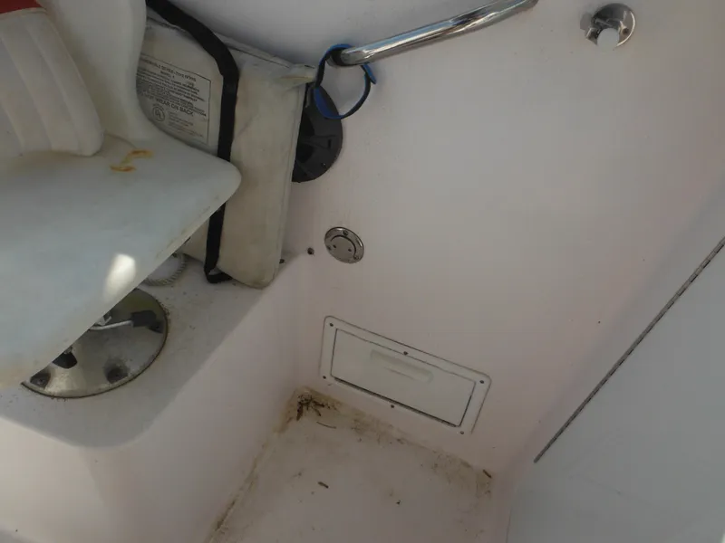 Slide: The Image of 2002 Pro-Line 23 Walk boat interior with seat, storage, and safety equipment. - 28