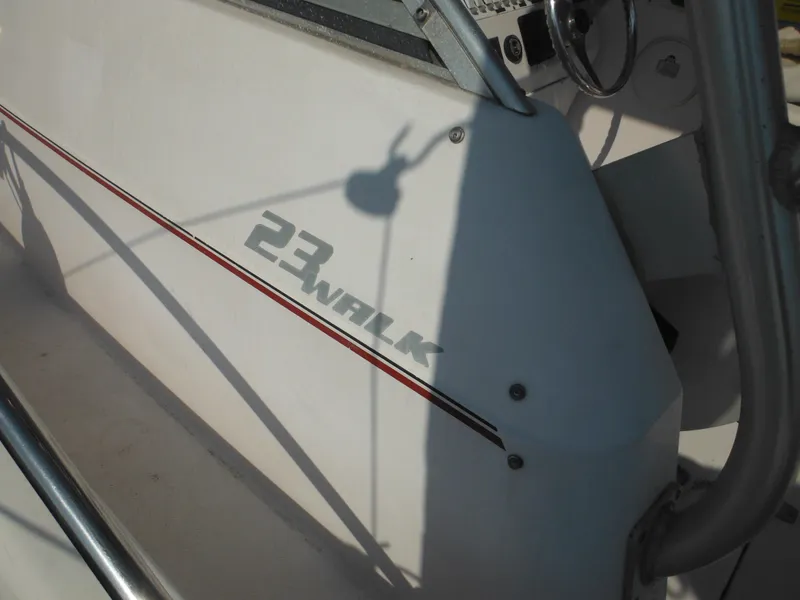 Slide: The Image of 2002 Pro-Line 23 Walk boat console with steering wheel and model branding. - 31