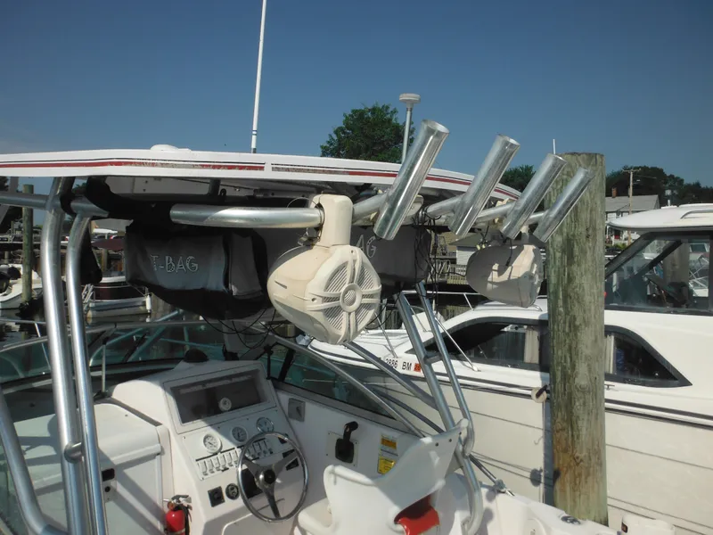 Slide: The Image of 2002 Pro-Line 23 Walk boat dashboard with rod holders and marine equipment. - 32