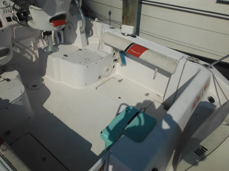 Slide: The Image of 2002 Pro-Line 23 Walk boat interior with seating and steering wheel. - 6