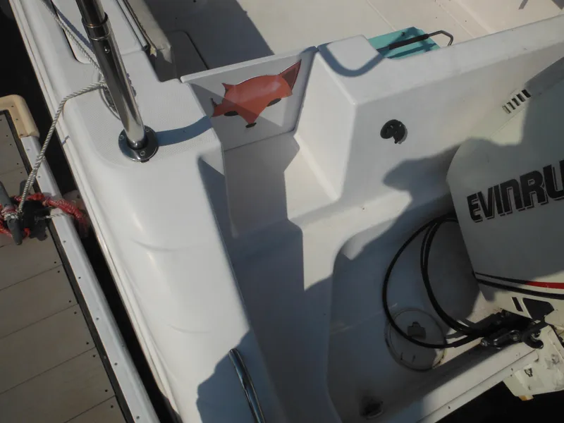 Slide: The Image of 2002 Pro-Line 23 Walk boat interior with Evinrude motor, docked. - 7