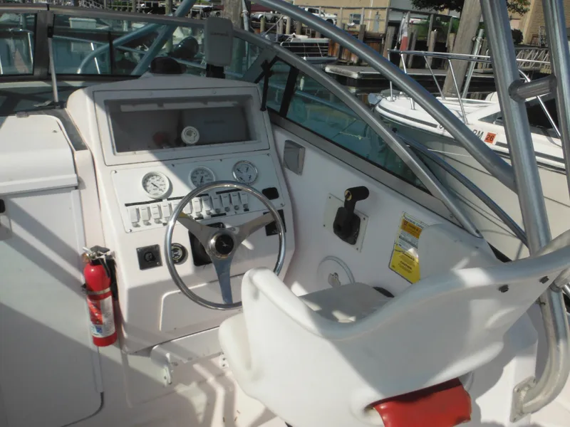 Slide: The Image of 2002 Pro-Line 23 Walk boat cockpit with steering wheel and control panel. - 8