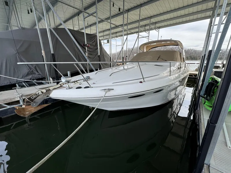 The Image of 2001 Sea Ray 310 Sundancer docked in a covered marina. - 1