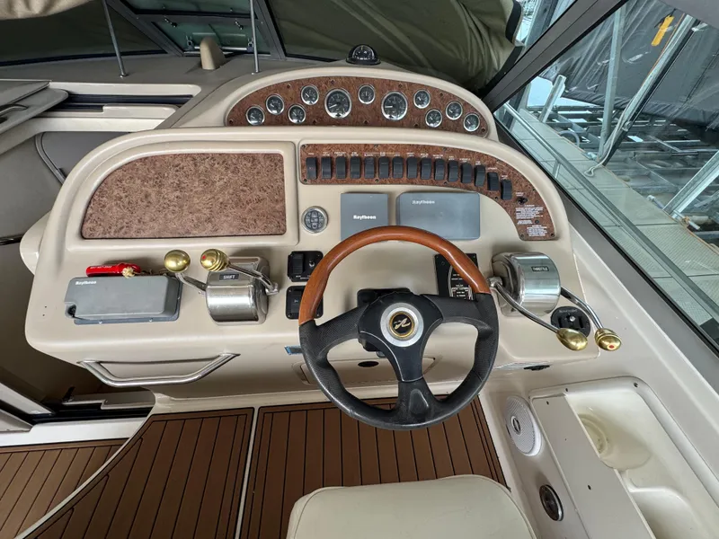 Slide: The Image of Cockpit of 2001 Sea Ray 310 Sundancer with steering wheel and control panel. - 12