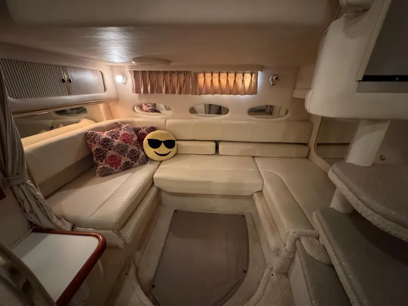 Slide: The Image of 2001 Sea Ray 310 Sundancer cabin interior with plush seating and decorative pillows. - 6