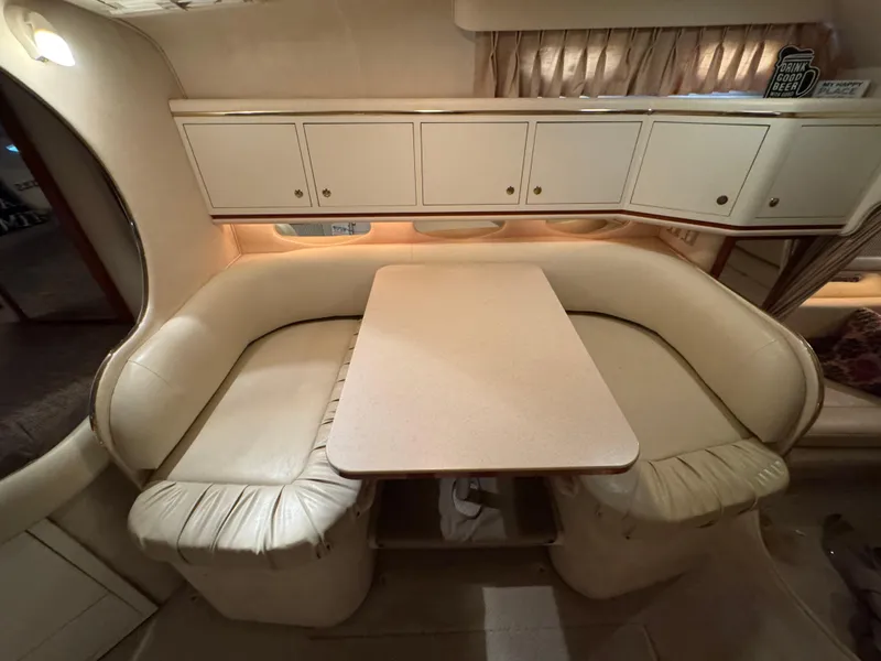 Slide: The Image of 2001 Sea Ray 310 Sundancer interior with cream leather seating and dining table. - 7