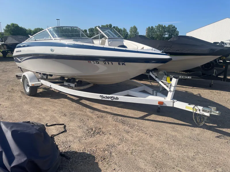 Slide: The Image of 2002 Crownline 180 BR boat on trailer in outdoor setting. - 13