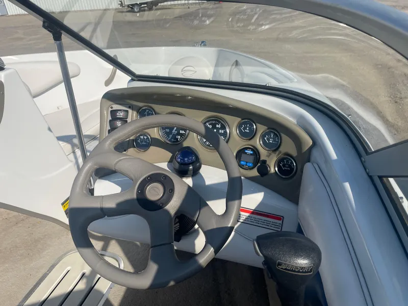 Slide: The Image of 2002 Crownline 180 BR boat dashboard with steering wheel and instrument panel. - 21