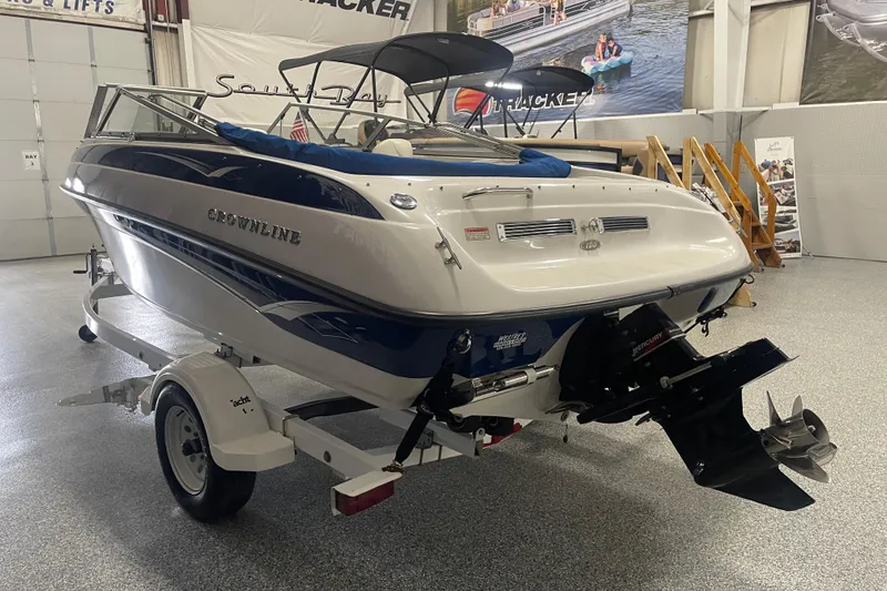 Slide: The Image of 2002 Crownline 180 BR boat on trailer in showroom, rear view. - 3