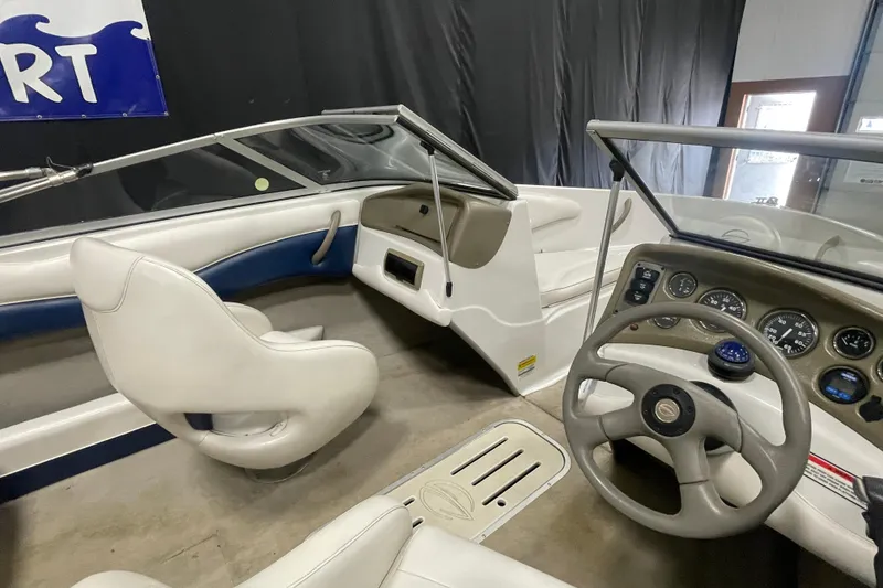 Slide: The Image of 2002 Crownline 180 BR boat interior with steering wheel and dashboard controls. - 9