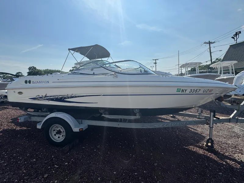 The Image of 2003 Glastron SX 195 boat on trailer, side view, sunny day. - 1