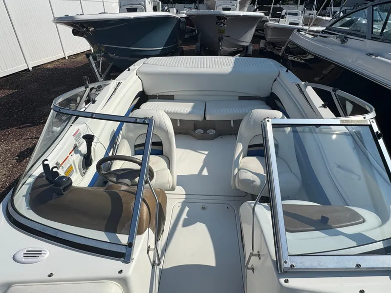 Slide: The Image of 2003 Glastron SX 195 boat interior with white seating and steering wheel. - 11