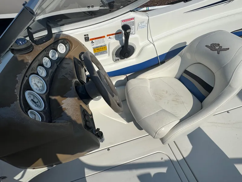 Slide: The Image of 2003 Glastron SX 195 boat cockpit with steering wheel and gauges. - 12