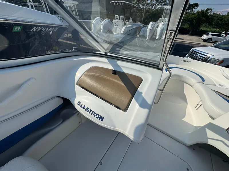 Slide: The Image of 2003 Glastron SX 195 boat interior with windshield and seating area. - 17