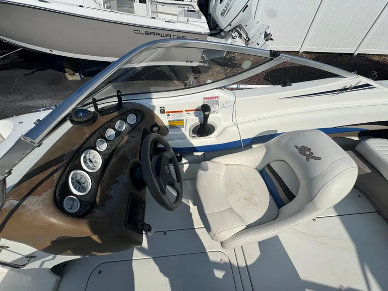 Slide: The Image of 2003 Glastron SX 195 boat interior with steering wheel and dashboard controls. - 18